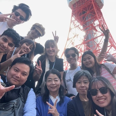Students selfie group shot with Tokyo tower in the background. 