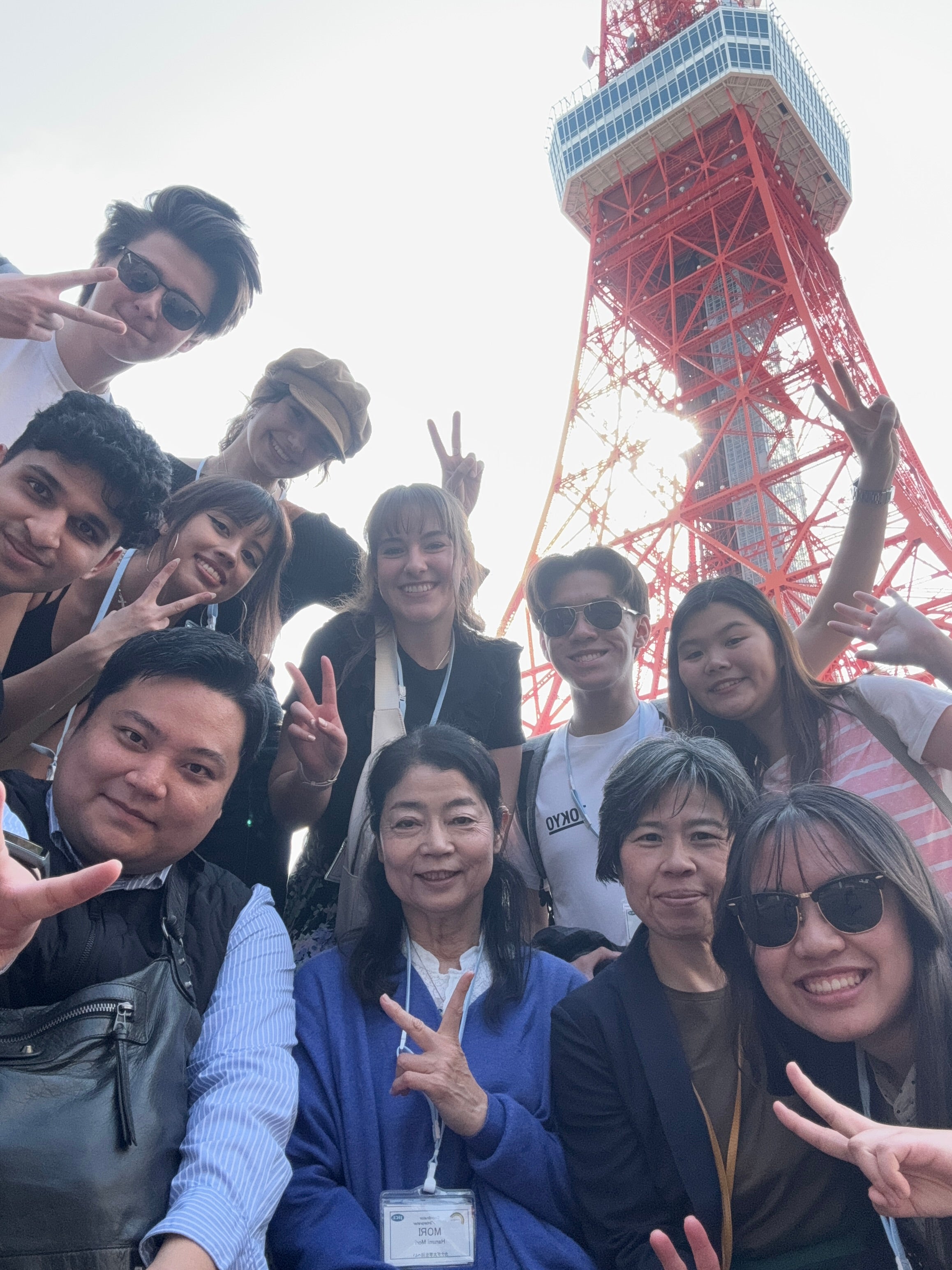 Students selfie group shot with Tokyo tower in the background. 