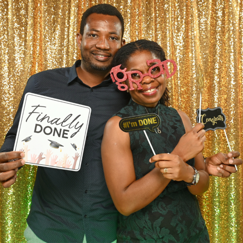 Two PhD grad celebration attendees in the photobooth