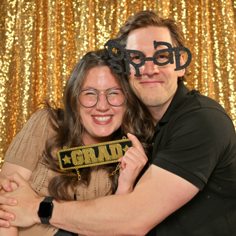 Two PhD grad celebration attendees in the photobooth