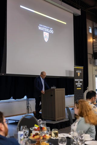 Jeff Casello speaking at a podium.