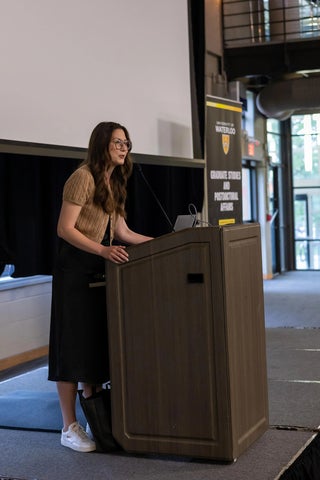 Emma Juracic speaking at a podium. 