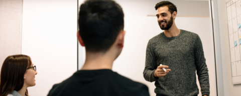 Student presenting to two colleagues