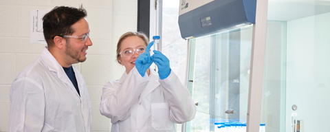 Students in a lab looking at a sample