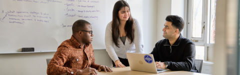 Three students working together at a table