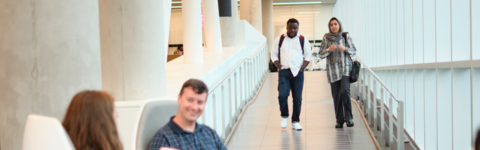 Two students walking in the SLC