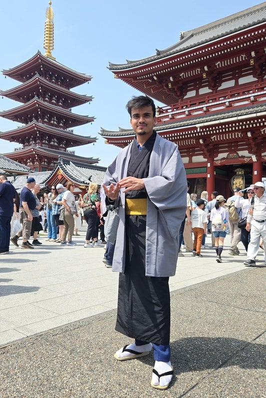 Rishabh Bajaj in traditional Japanese wear in front of traditional Japanese buildings