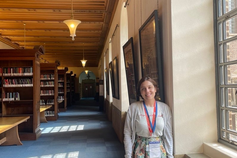 Atiyeh Ahmadi standing in a library