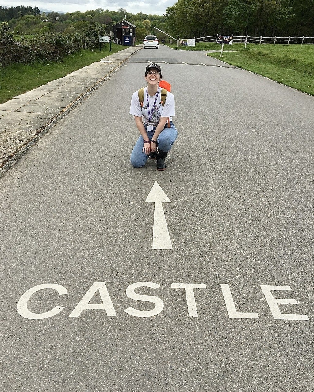 Katie Pita with a sign pointing to a castle
