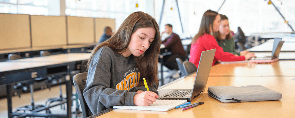 Student writing in a notebook