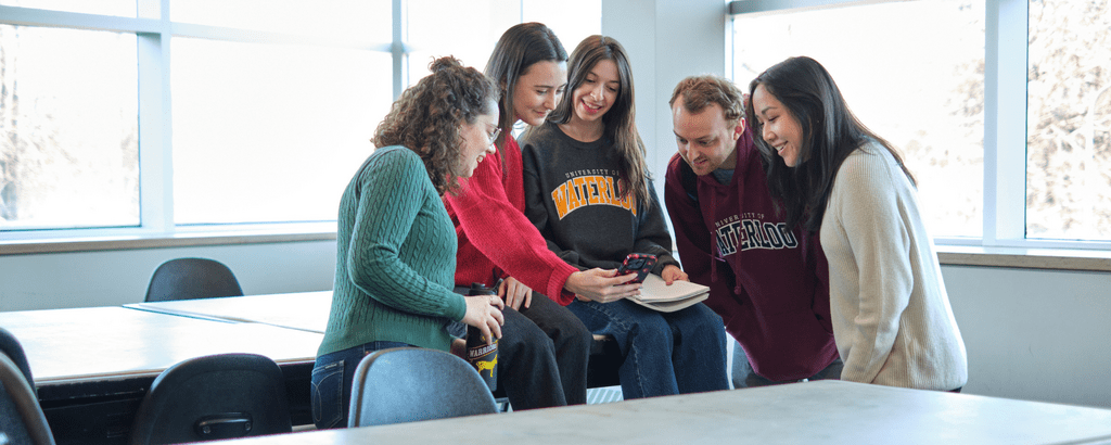 Students looking at a phone together