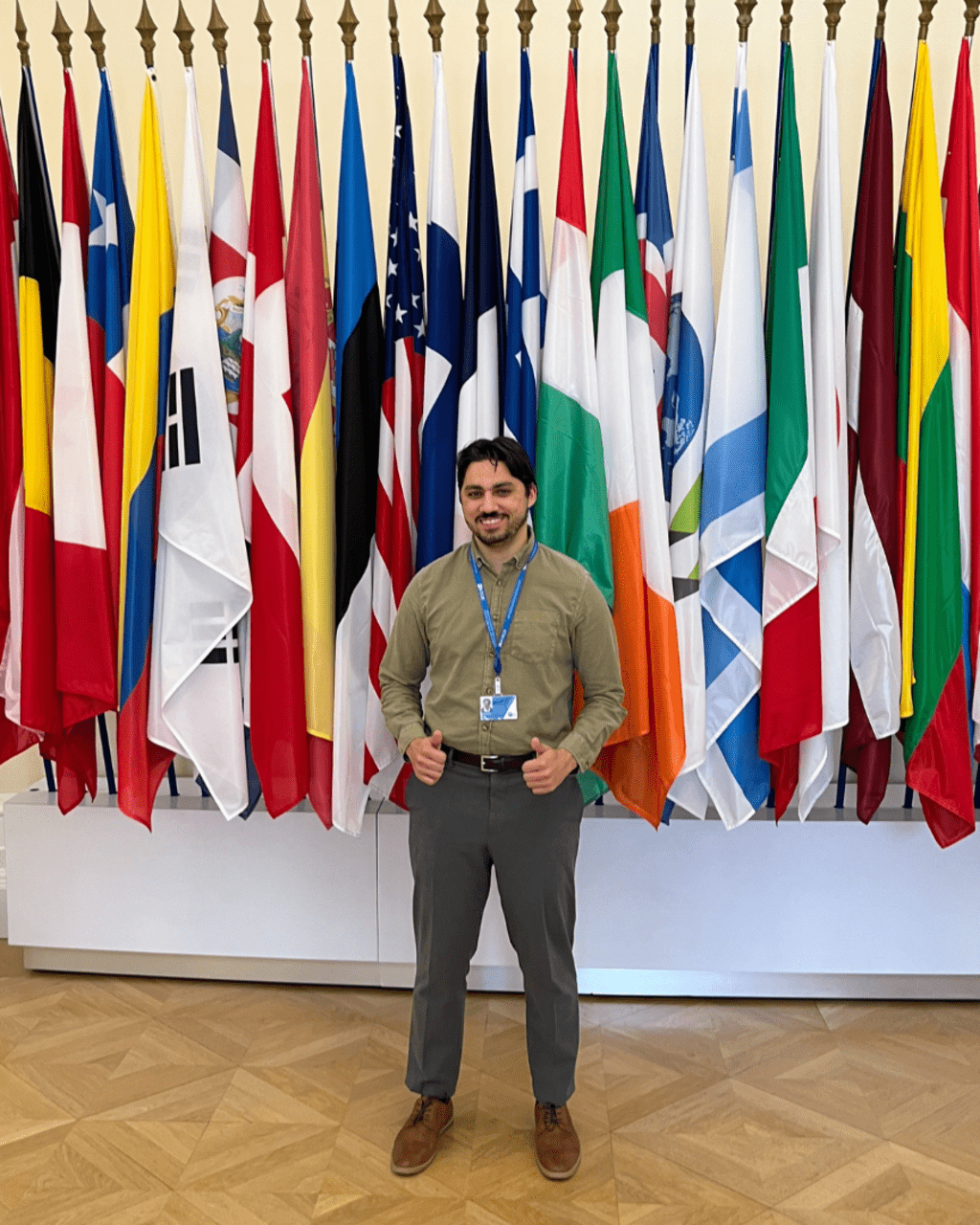 Timothy Crincoli in front of a wall of flags