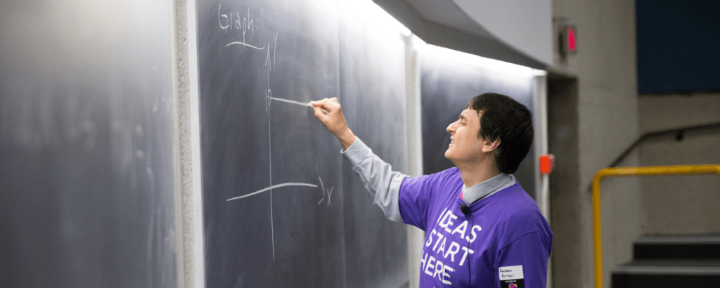 Professor giving a sample lecture to prospective students.