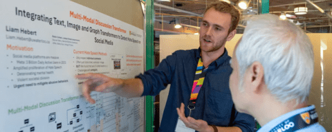 Liam Hebert presenting a poster