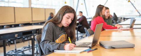 Student writing in a notebook