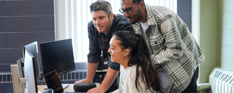 Students looking at a computer together