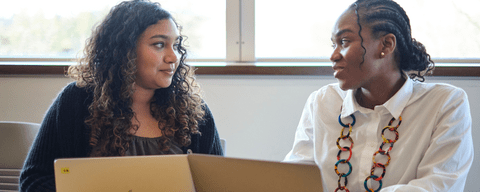 Students talking and on laptops