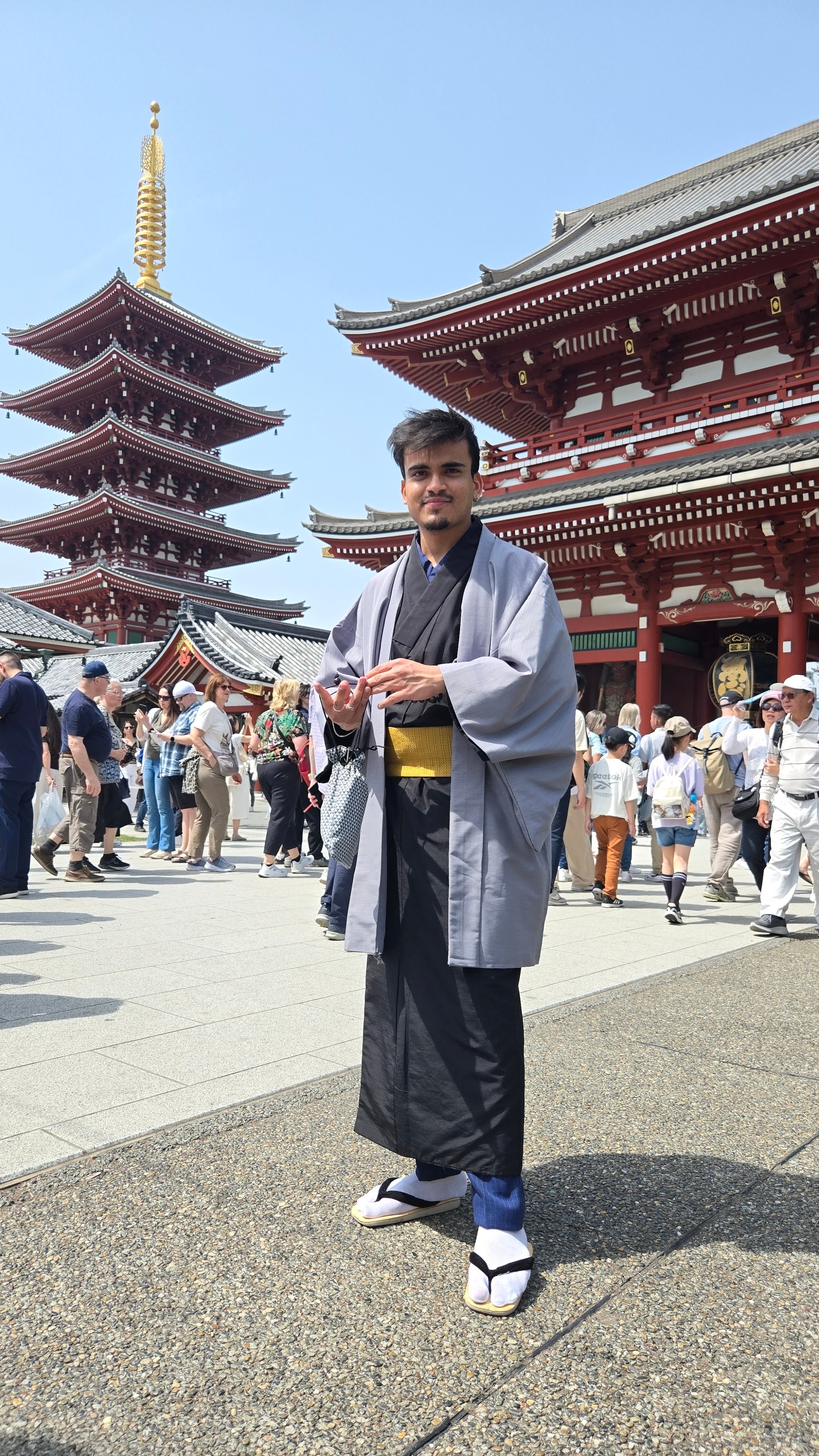 Rishabh Bajaj in traditional Japanese wear in front of traditional Japanese buildings