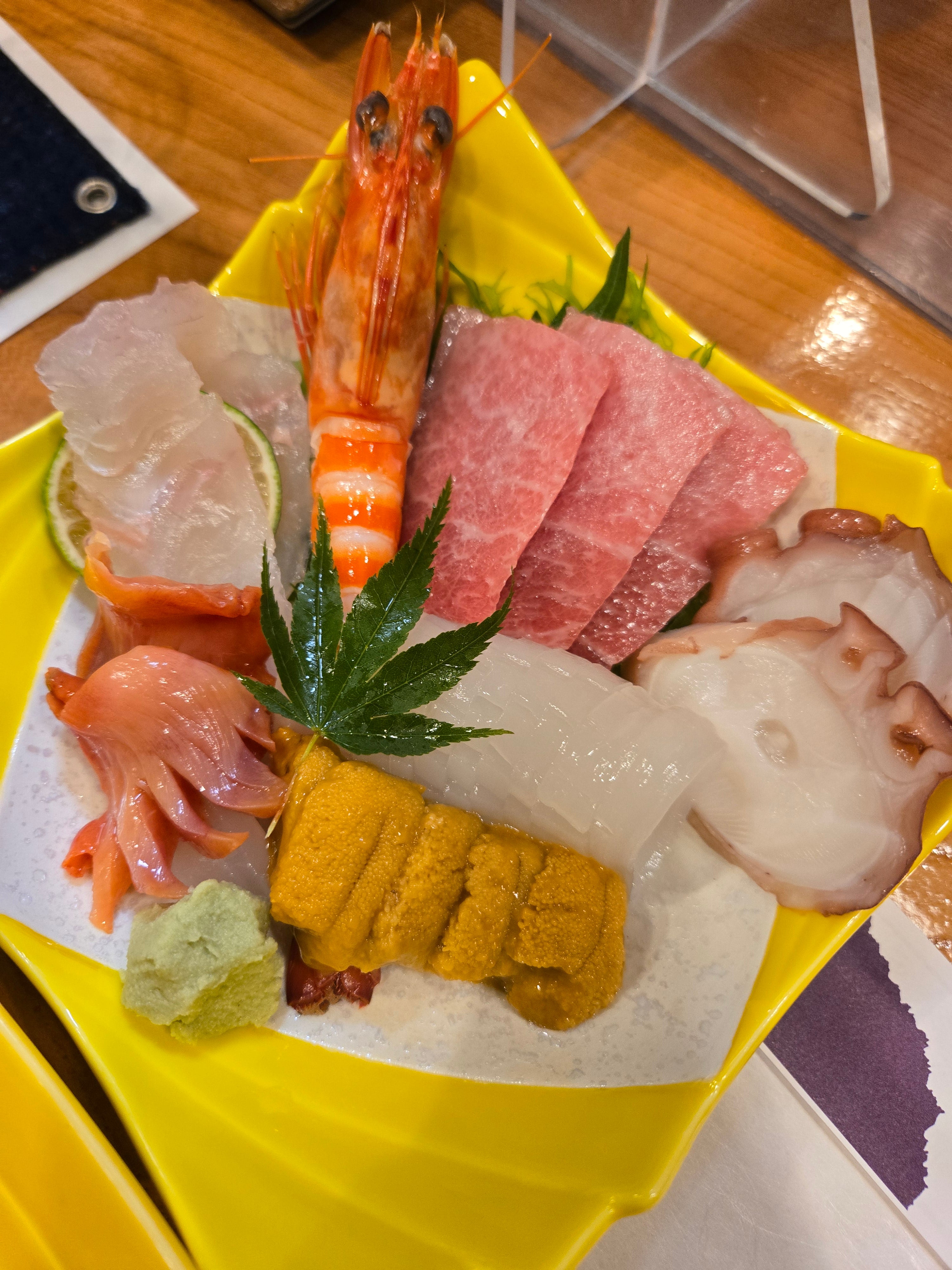 An array of seafood on a yellow plate