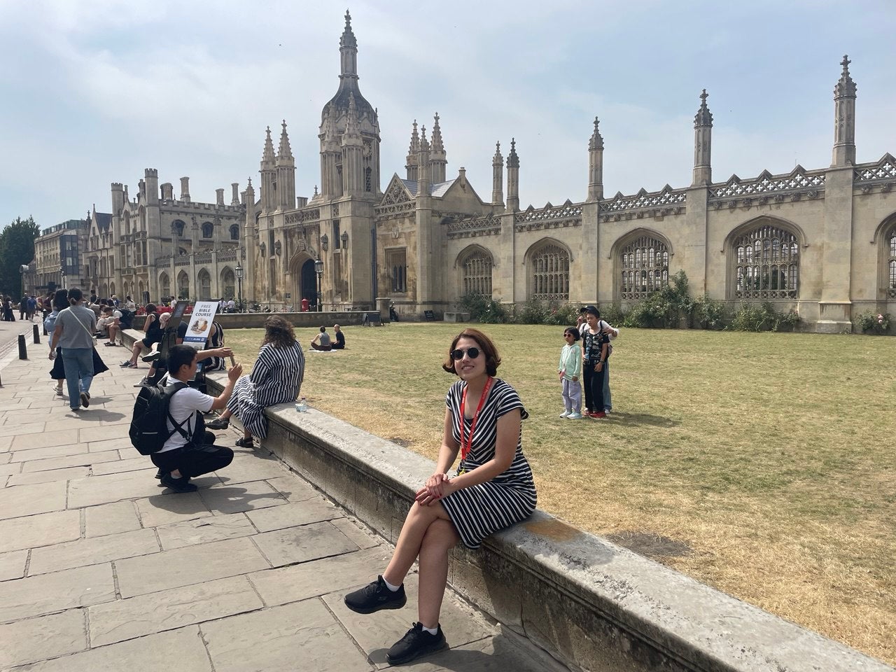 Atiyeh Ahmadi sitting in front of historic looking building