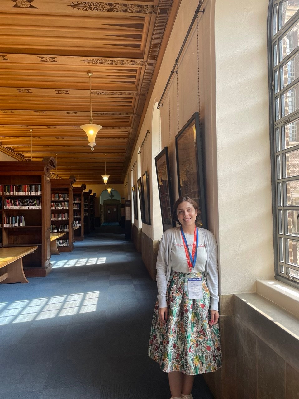 Atiyeh Ahmadi standing in a library