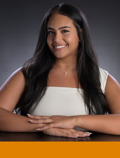Headshot of graduate student, Alexandrine Marie Gabriel, with a solid orange block on the bottom
