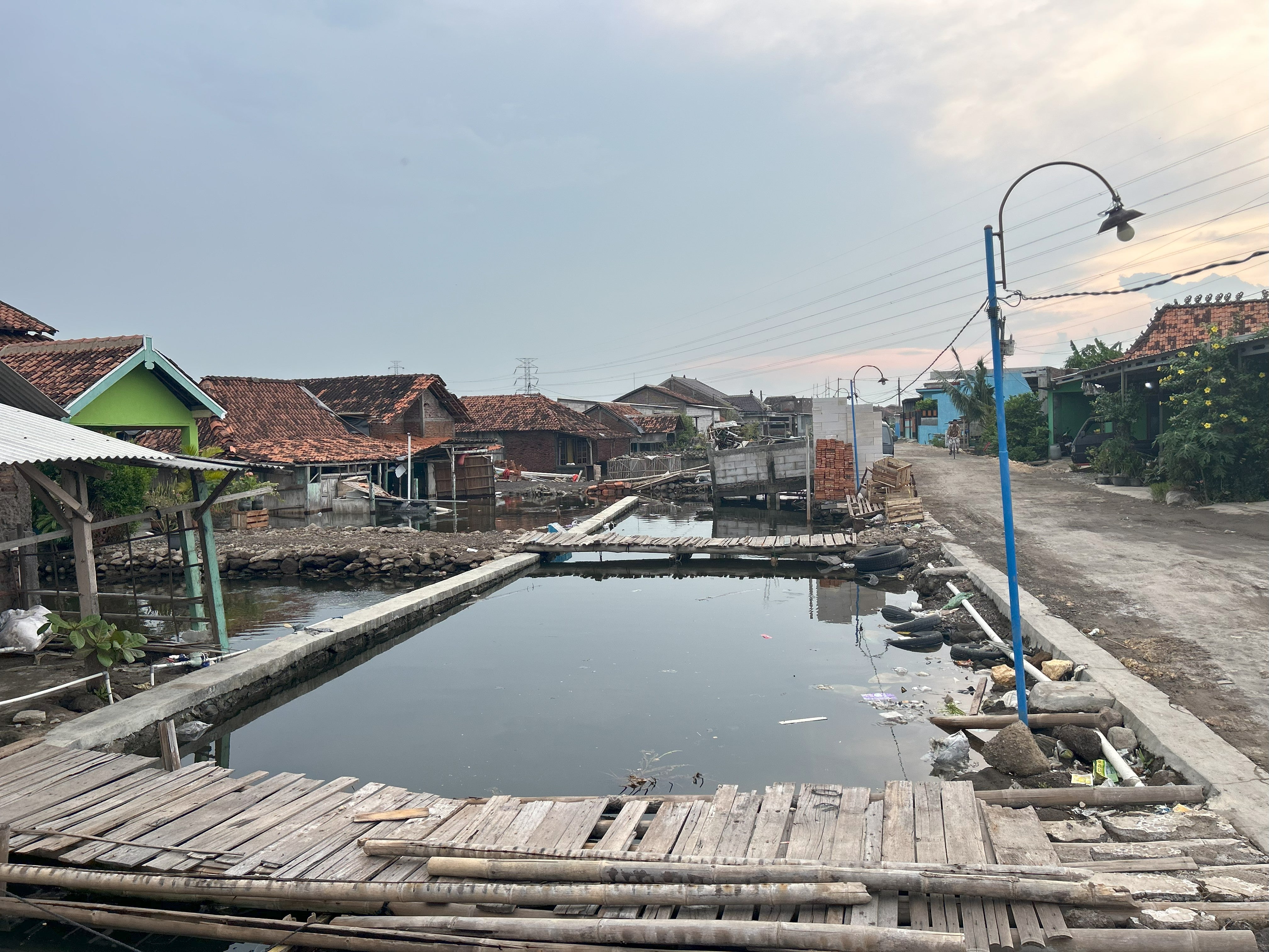 Makeshift wooden plank bridge over water