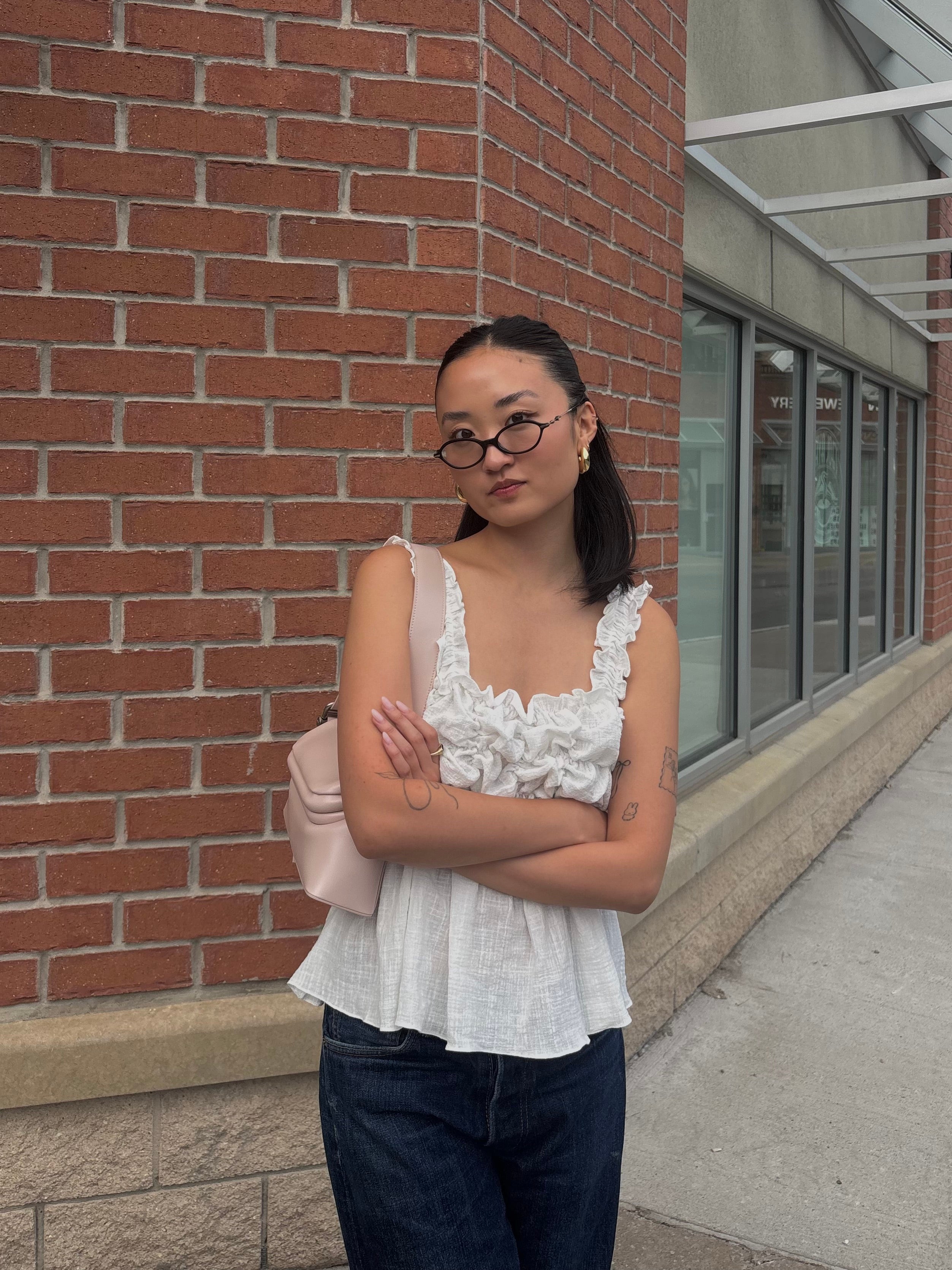 Alison Yu posing in front of a brick building