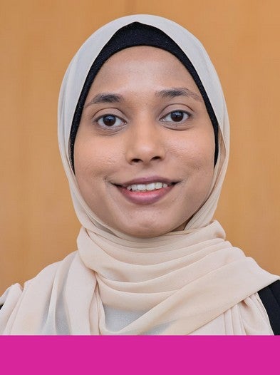 Headshot of graduate student Malia Ahmed. A pink rectangle borders the bottom of the photo.