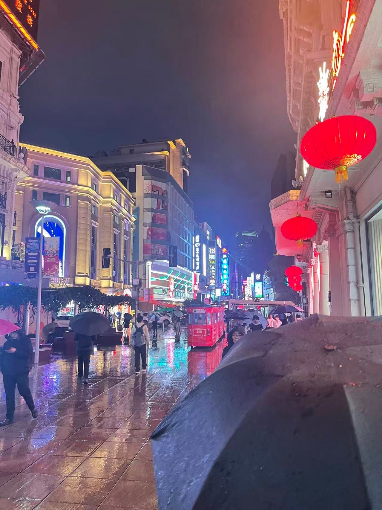 A street in China full of people with umbrellas.