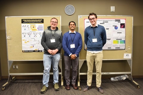 CPI annual conference poster winners Thomas Humphries and Ross Evans standing beside judge Sajin Sasy