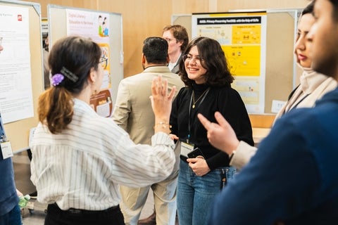 Graduate students presenting posters 