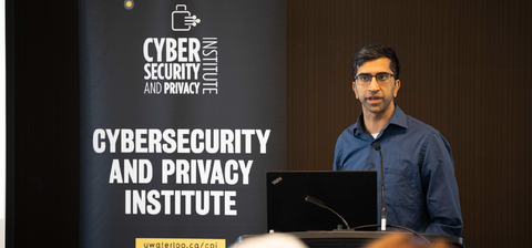 CPI's Gautam Kamath at the podium speaking about differential privacy