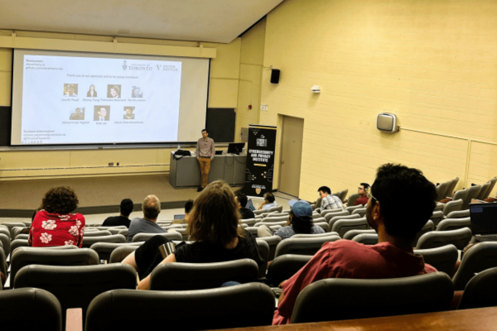 people sitting and watching lecture presented on screen