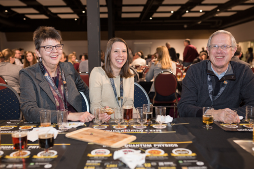 Three people try samples of Ontario craft beer at the Beer + Quantum event.