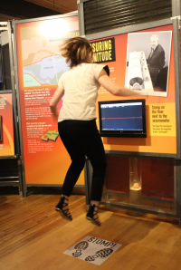 A woman attempts to make a seismic device register through jumping.