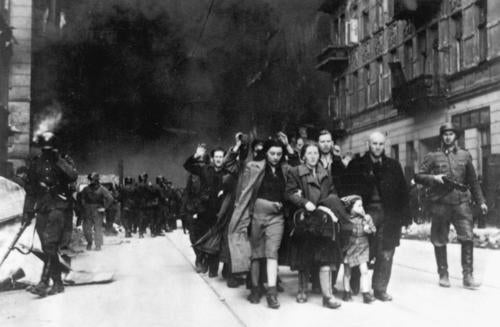 Jewish people held at gunpoint in the Warsaw Ghetto.