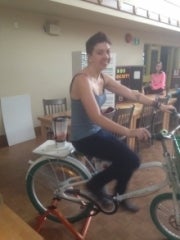 A volunteer rides a stationary Energy Bike.