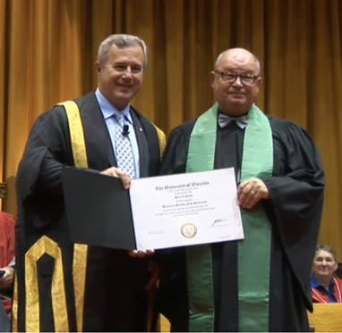 Chancellor Tom Jenkins and Pat Mihm at Convocation with the honorary member certificate.