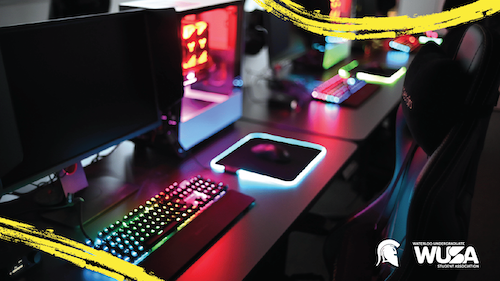 An Esports gaming setup featuring backlit computer keyboards and computer monitors, with the WUSA and Warriors logos.