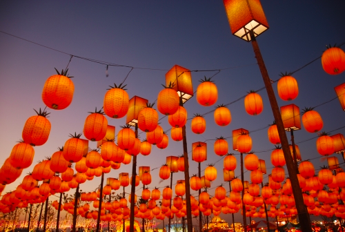 Rows of red paper lanterns on poles and wires.