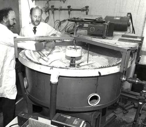 Professor Peter Silveston (left) and Professor Robert Hudgins work with a model sewage treatment aerator in their lab.