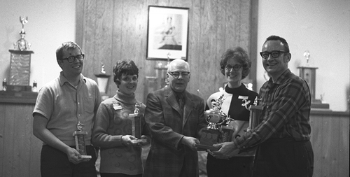 Curlers holding trophies pose with President Gerald Hagey in this undated photo.