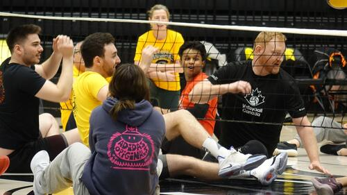 Nasif Chowdhury (in red shirt) and other participants at an exhibition of sitting volleyball at the University of Waterloo.
