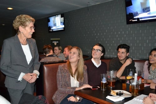 Premier Kathleen Wynne speaks with students at The Bombshelter Pub.