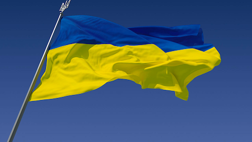 A Ukrainian flag against a clear blue sky.