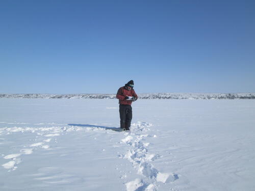 Dr. Claude Duguay conducting research during a field visit in Inuvik