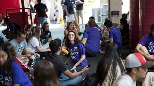 Engineering students sit on the floor during an orientation event.