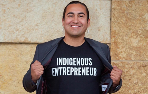 Jacob Crane poses with a t-shirt that says &quot;Indigenous Entrepreneur.&quot;