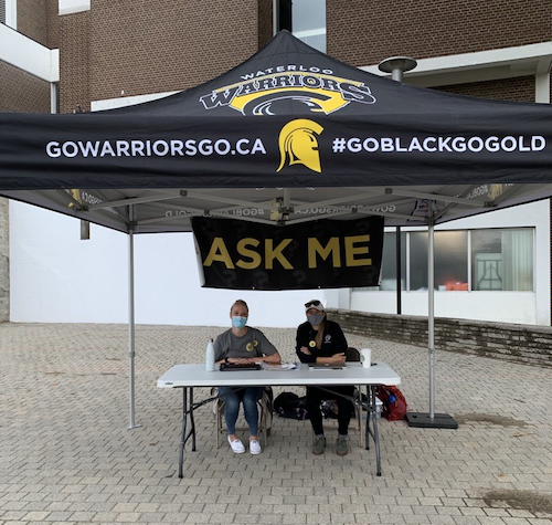 Volunteers at an information booth outside South Campus Hall.